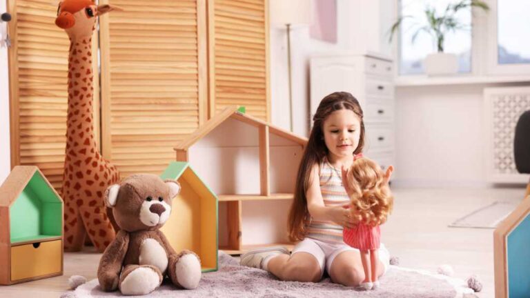 Child playing with autistic Barbie, highlighting autism-friendly toys and inclusive, play-based learning.