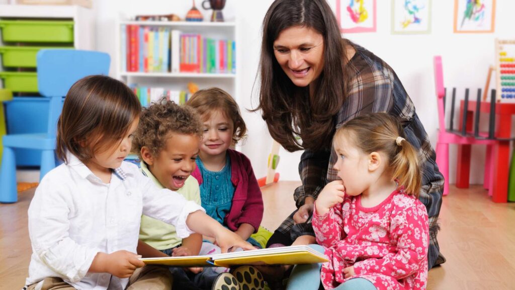 Children gathered around an adult in storytime reading books for kids with autism
