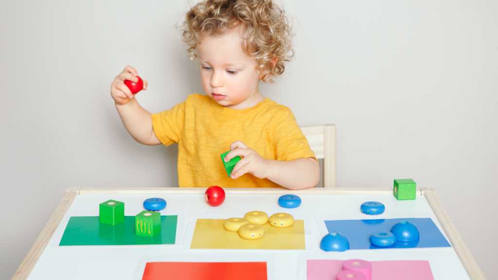 Toddler practicing color sorting during ABA therapy for toddlers