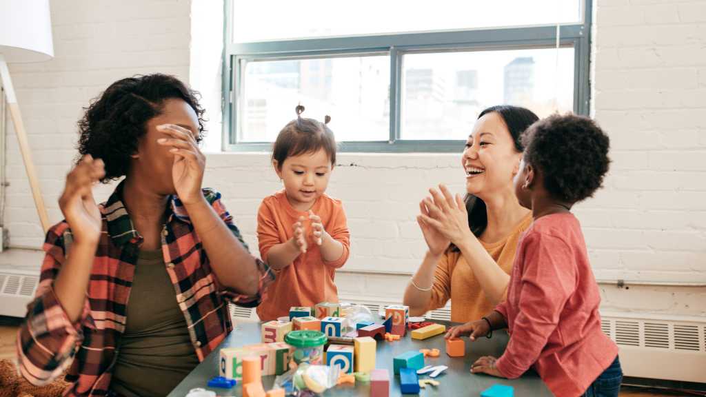 Toddlers and caregivers practicing social play during ABA therapy
