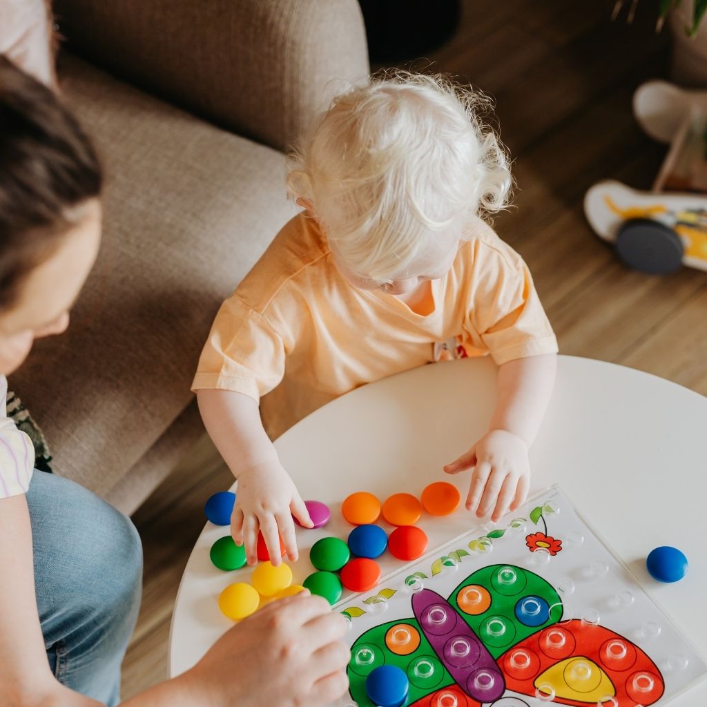 Toddler playing with colorful learning toys during an activity