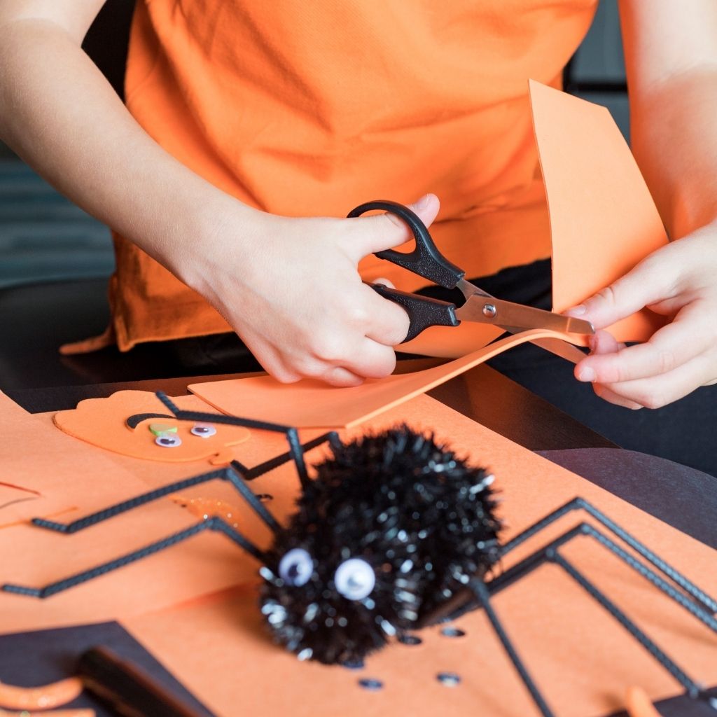 Kids making Halloween decorations for a sensory-friendly halloween