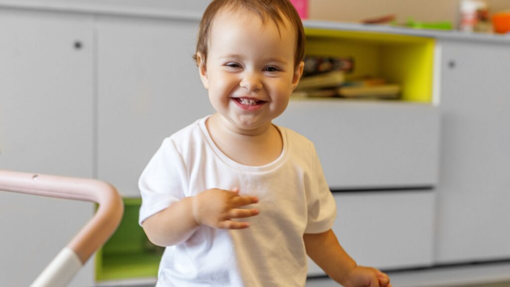 Smiling toddler participating in an early childhood setting session about age for ABA therapy